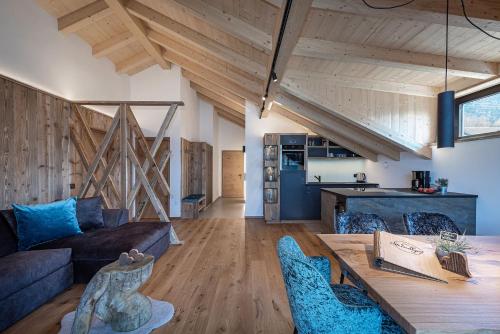 a living room with a couch and a table at Steindlgut - Weinberg Chalets in Brixen