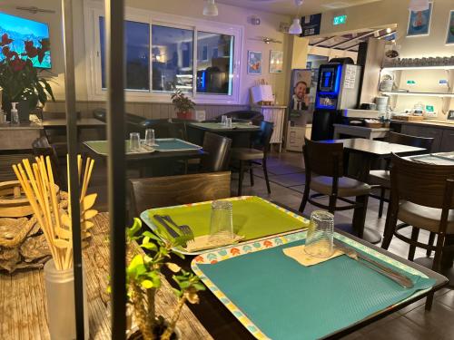a dining room with tables and chairs and a restaurant at BRIT HOTEL Lannion-Perros Guirec in Lannion