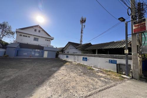 an empty street in front of a white building at JT Place Buriram in Buriram