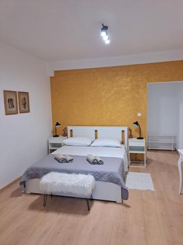 a bedroom with a large bed and two tables at Sweet home in Rab