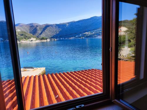 a view of a lake from a window at Villa Mali Raj in Zaton