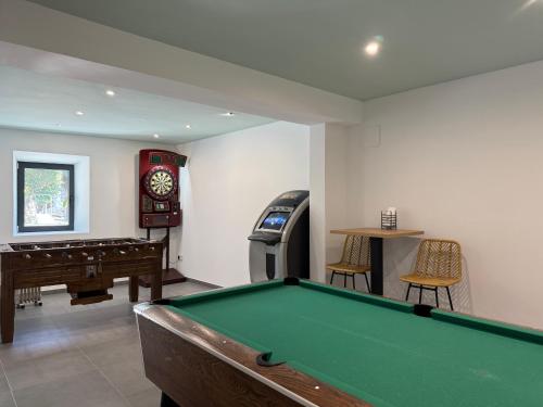 a living room with a pool table and a clock at Cazorla Estelar in Cazorla