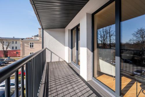 a balcony of a building with glass windows at Apartamenty Rocha in Pabianice
