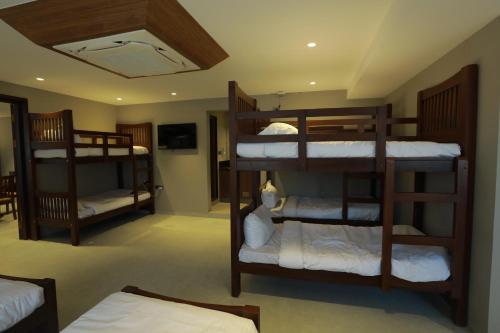 a room with three bunk beds in a room at Chakkra Grand in Madurai