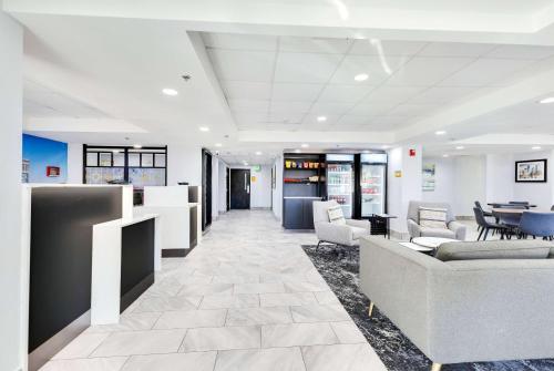 a lobby with couches and chairs and a table at La Quinta Inn & Suites by Wyndham Jacksonville Mandarin in Jacksonville
