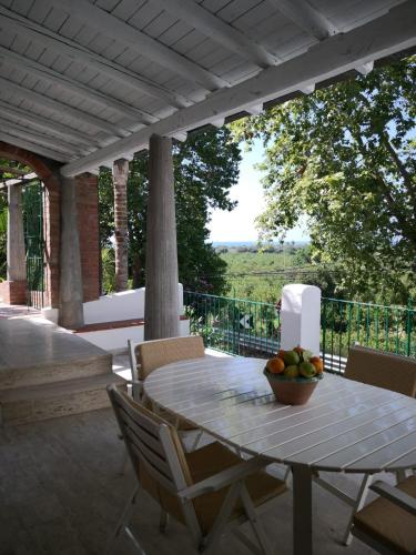 a table with a bowl of fruit on a patio at Un'oasi tra i limoni in Naso