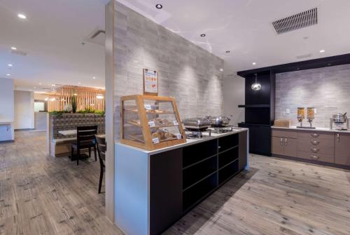 a kitchen with a counter and a dining room at Microtel Inn & Suites by Wyndham Oyster Bay Ladysmith in Ladysmith