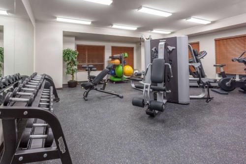 a gym with several treadmills and machines at Microtel Inn & Suites by Wyndham Oyster Bay Ladysmith in Ladysmith