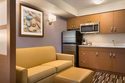 a living room with a couch and a kitchen at Microtel Inn & Suites by Wyndham Oyster Bay Ladysmith in Ladysmith