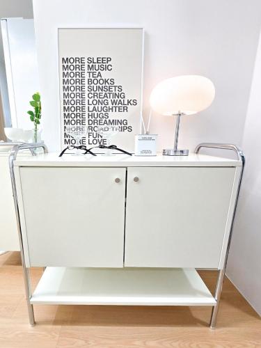 a white cabinet with a lamp on top of it at stable home#신축#천호역2분#KSPO#롯데월드#롯데타워#아산병원#코엑스#가족여행#장박할인 in Seoul