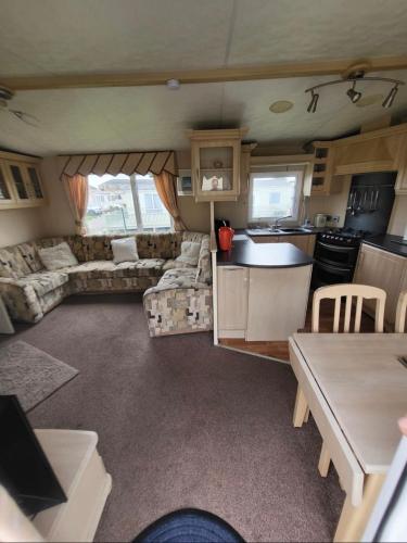 a kitchen and living room of a caravan at SKEGNESS GOLDEN PALM HOLIDAY HOME Pg 52 in Skegness
