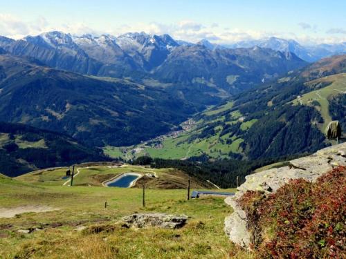 a view of a valley with mountains in the background at Chalet in Königsleiten near Alpine Peaks in Königsleiten