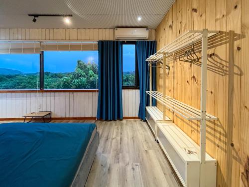 a bedroom with a bunk bed and a window at The Lake House Retreat & Watersports in Tân Phú