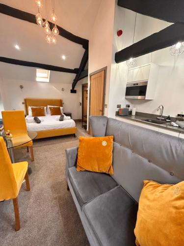 a living room with a couch and a bed at Rigney Bank House, South Lakes Luxury Apartments in Milnthorpe