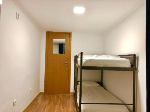 a small room with a bunk bed and a door at 4Lisbon Downtown Private Bedroom City View in Lisbon