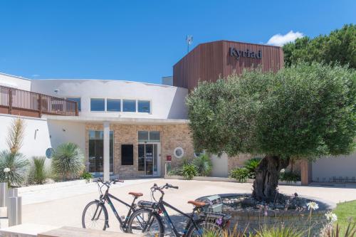 two bikes parked in front of a building at Kyriad Montpellier Est - Lunel in Lunel