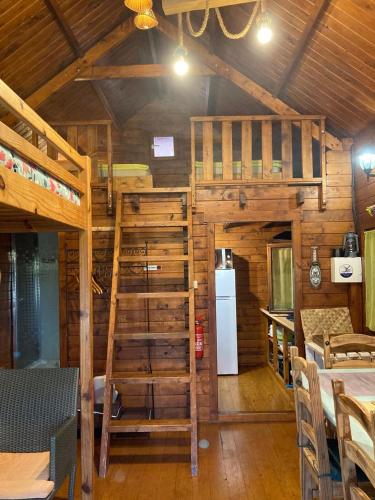 a cabin with two bunk beds and a refrigerator at La Cabane du Raideur in Cilaos