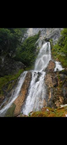 a waterfall on the side of a mountain at Το ΦΑΡΑΓΓΙ ΤΟΥ ΠΑΡΝΑΣΣΟΥ 4 in Velítsa