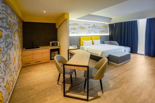 a hotel room with a bed and a table and chairs at Yello Hotel Harbour Bay in Nagoya