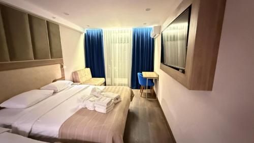 a hotel room with a bed with towels on it at Adlia Flight Spot in Batumi