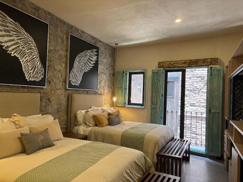 a bedroom with two beds and a window at Castello di Carlo - Loft Carlo II in Santeagueda