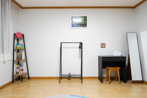 a room with two mirrors and a table and a stool at stayok Okpo, center of Geoje in Geoje 