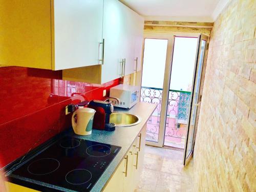 a kitchen with a sink and a counter top at 7Lisbon Downtown Private Bedroom With Balcony in Lisbon