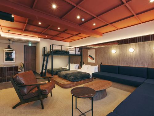 a bedroom with a bunk bed and a couch at illi Mani Shibuya in Tokyo