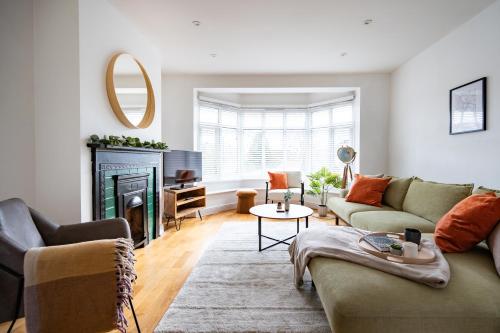 a living room with a couch and a fireplace at 4 Bed Sheffield House with Parking leisure or contractor in Fulwood