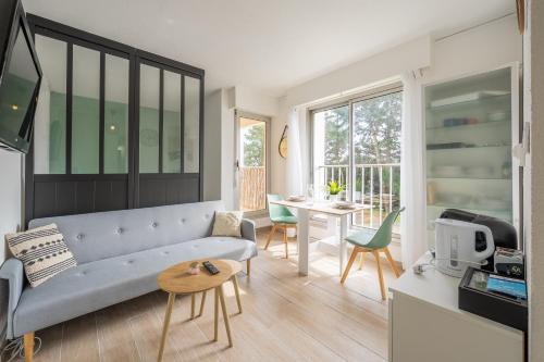 un salon avec un canapé et une table dans l'établissement Le Studio des Dunes - A 50m de la plage, à Soulac-sur-Mer