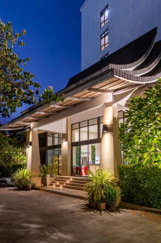 a house with lights on the front of it at Recenta Phuket Suanluang in Phuket Town