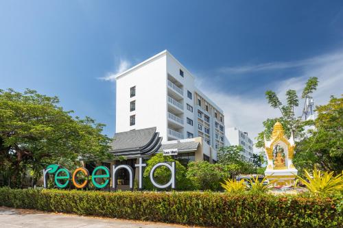 a hotel with a sign in front of a building at Recenta Phuket Suanluang in Phuket Town
