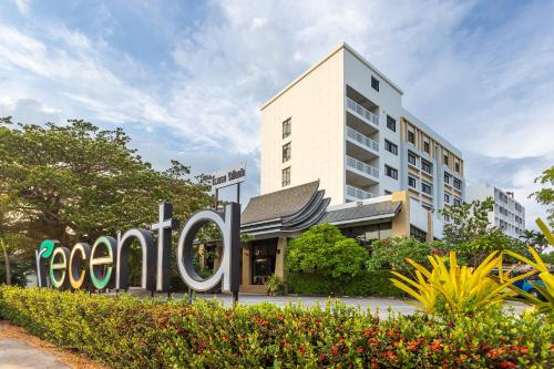 a hotel sign in front of a building at Recenta Phuket Suanluang in Phuket Town