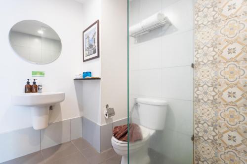 a bathroom with a toilet and a sink and a shower at Recenta Phuket Suanluang in Phuket Town
