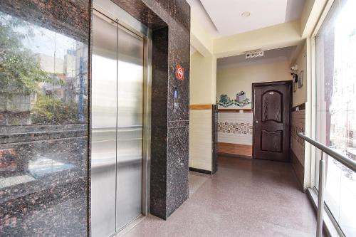 a hallway with a glass door in a building at FabExpress Ivory Pearl - BTM Layout in Bengaluru