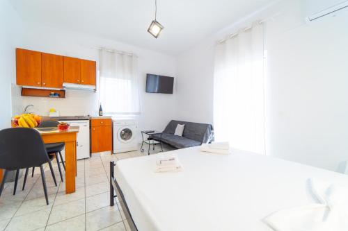 a kitchen with a table and a dining room at Beachfront Cozy Apartments in Ammoudara in Amoudara Herakliou