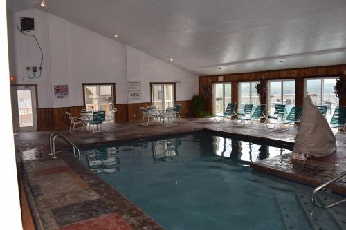 a large swimming pool in a building with chairs at Mountain View Retreats in Gatlinburg