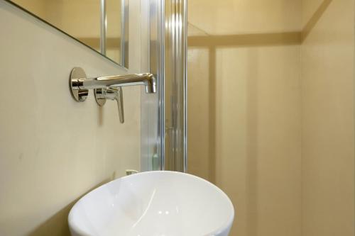 a white toilet in a bathroom with a shower at Artemida Beach House in Artemida