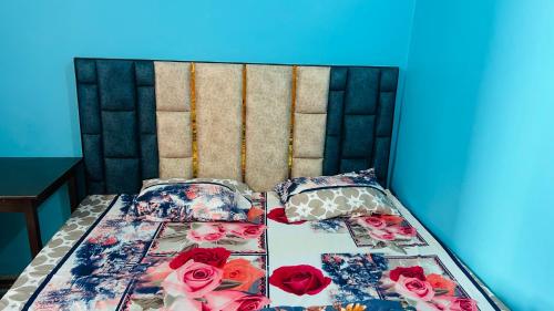 a bed with pink roses on top of it at Tandon Lodge On The Ganga Ghat Homestay in Varanasi