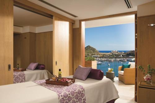 a hotel room with two beds and a large window at Breathless Cabo San Lucas - Adults Only in Cabo San Lucas