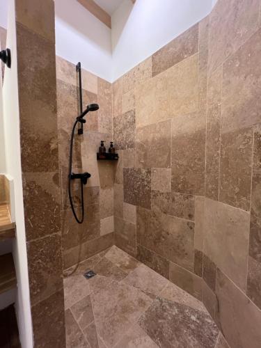 a bathroom with a shower with a shower head at Château d'Aynac in Aynac