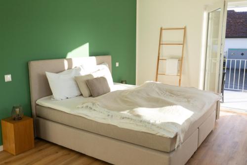 a bed with white sheets and pillows in a bedroom at BEST STAY Grüne Wohlfühloase Dietershausen in Künzell