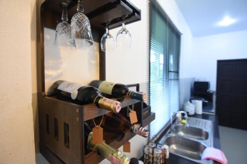 a bunch of wine bottles in a wine cellar at Baan Peaceful Villa 1, Ao Nang in Krabi town