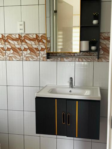 a bathroom with a sink and a mirror at Galaxy Villa room in Dalaguete