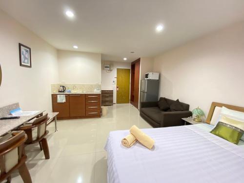 a bedroom with a bed and a living room at Dream Boutique Hotel in Cha Am