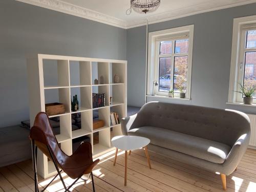 a living room with a couch and a table at Aalborg Villa Apartments - Close to Aalborg center - Free parking - Free citybikes in Aalborg