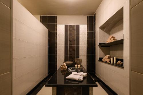 a bathroom with a black table with towels on it at Iberotel Redsina in Sharm El Sheikh