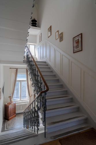 a staircase in a home with white walls at Le Relais de l'Orangerie in Strasbourg