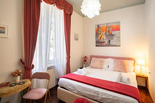 a small bedroom with a bed and a window at Pool and Relax at Casa Ilenia in Bordighera