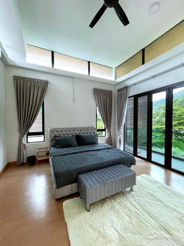 a bedroom with a large bed with a ceiling fan at cc la villa in Kanching